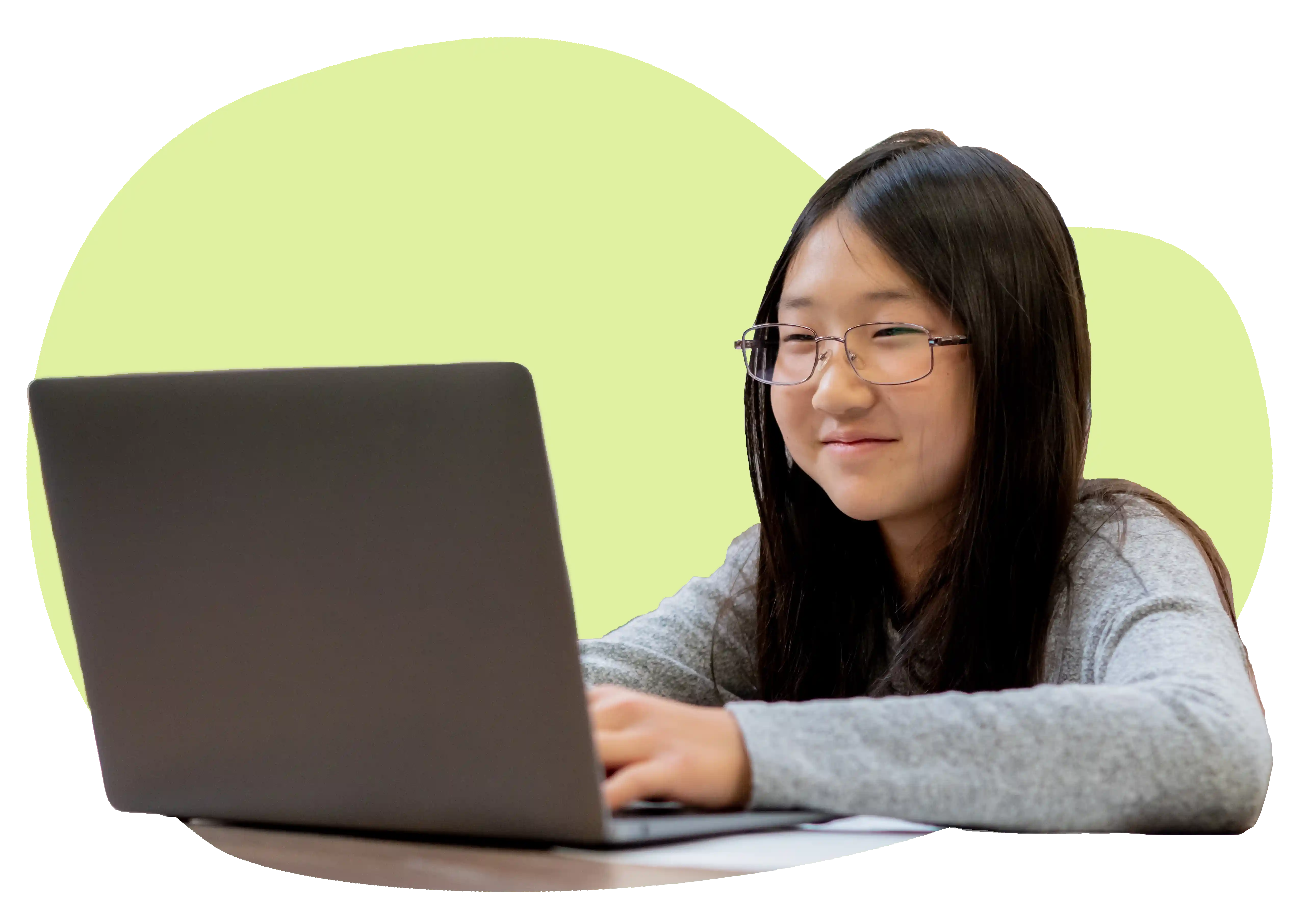 Student smiling at a laptop